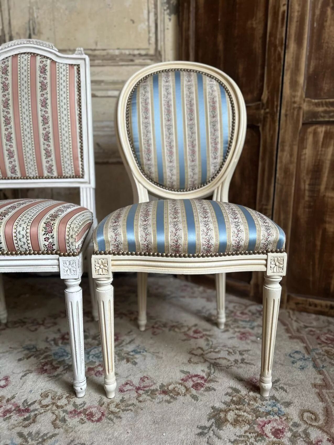 Pair of Louis XVI style chairs in painted wood and satin, classic elegance.