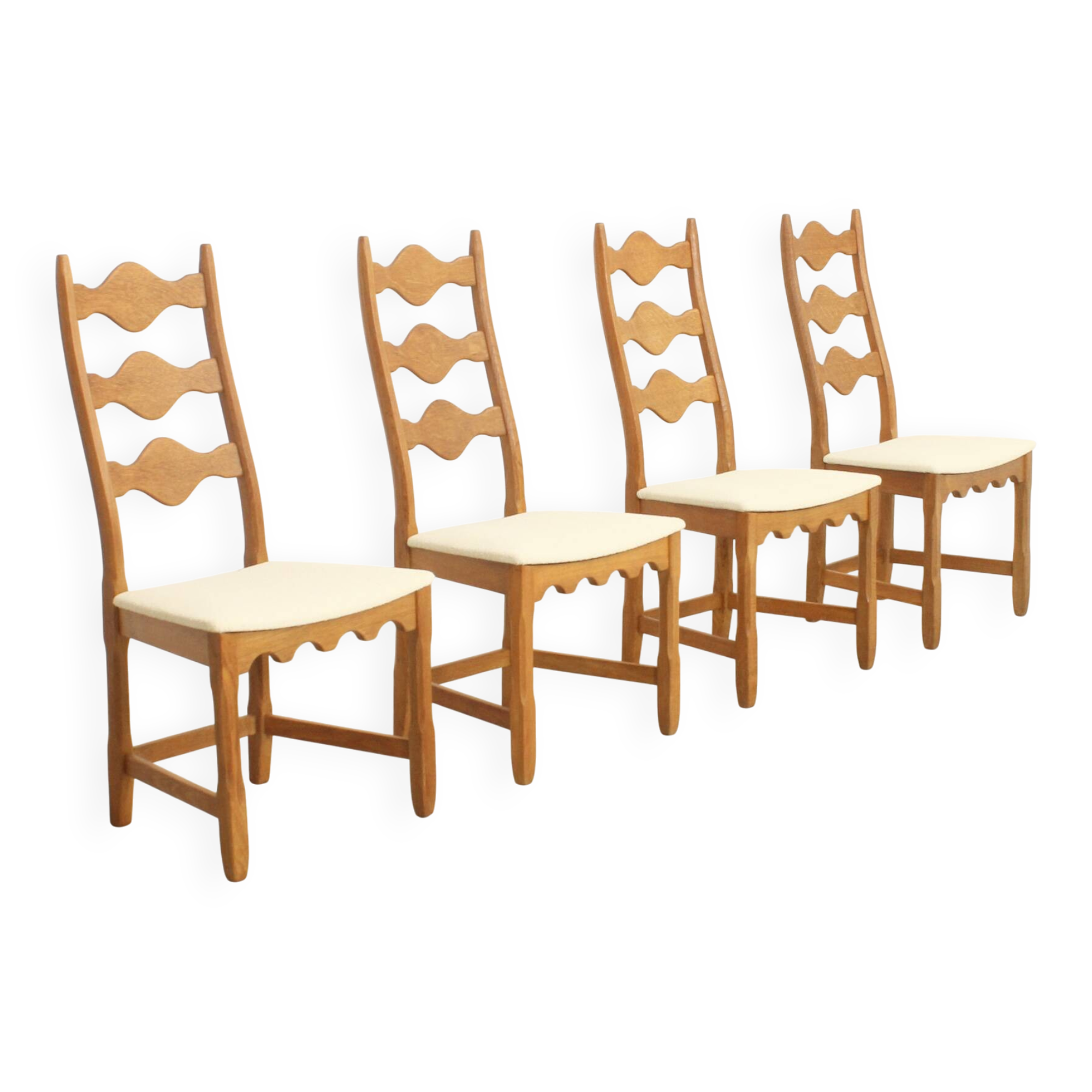 Four oak dining chairs by Henning Kjaernulf.