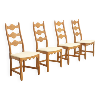 Four oak dining chairs by Henning Kjaernulf.