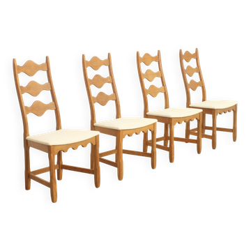 Four oak dining chairs by Henning Kjaernulf.