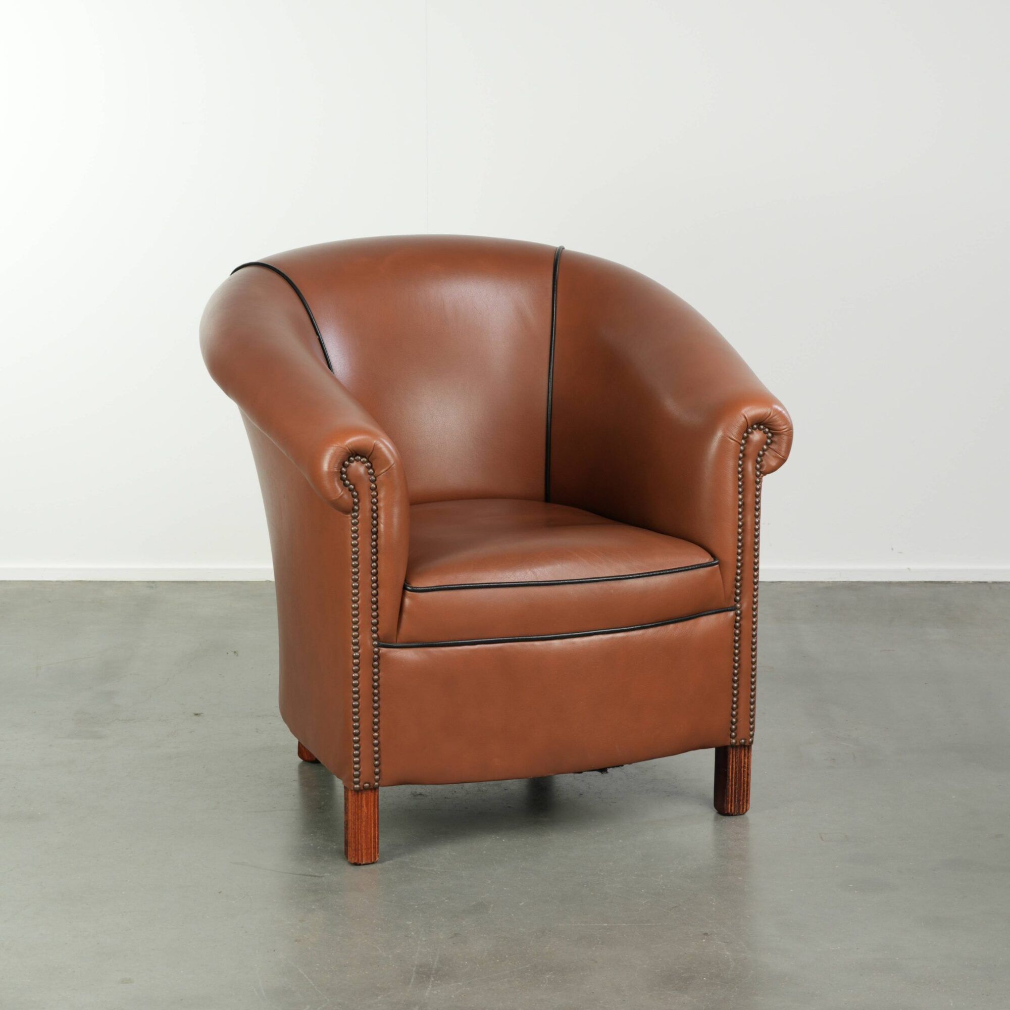 Cowhide club armchair in English style with comfortable seating.