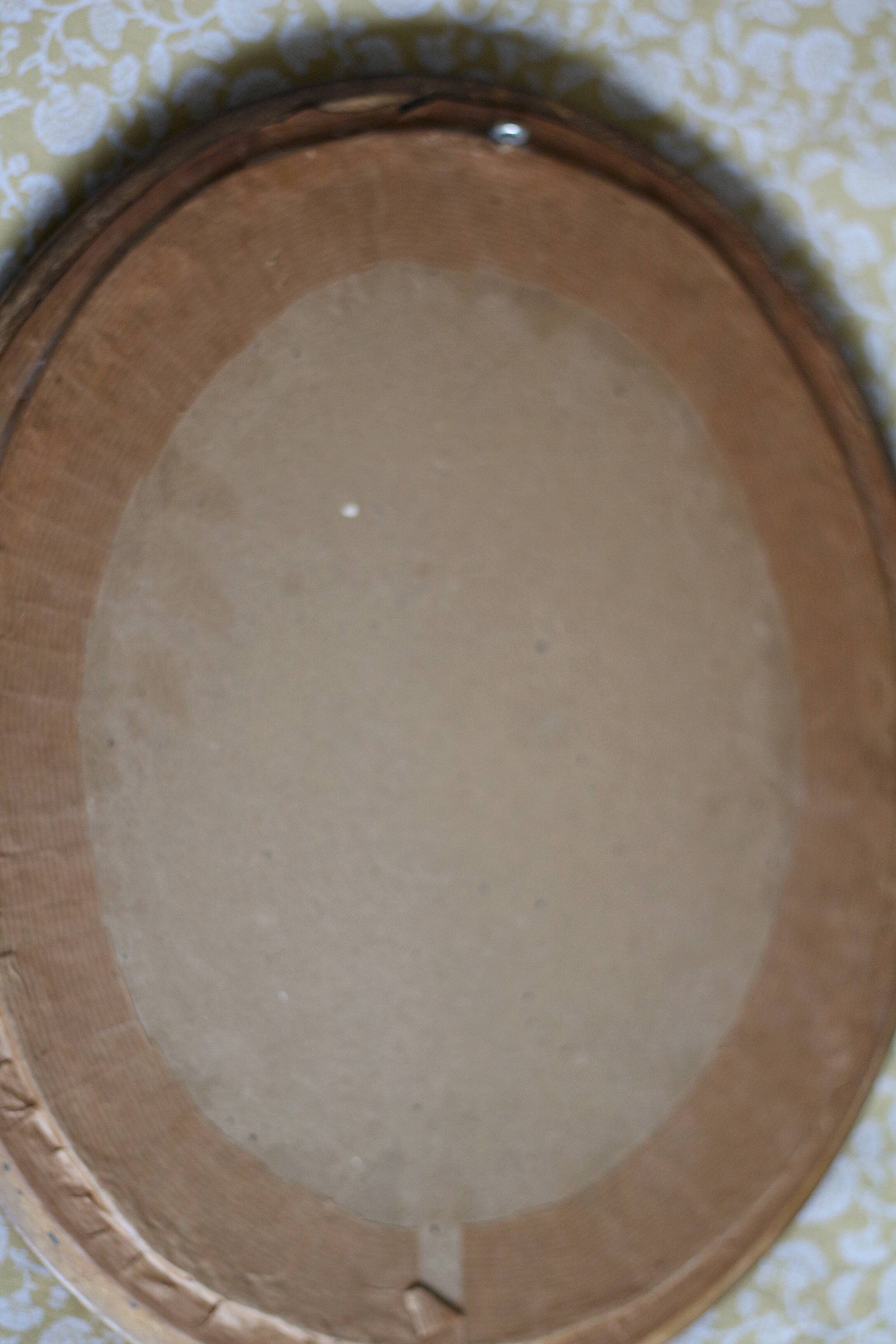 Oval wall mirror with gilded frame and mercury glass. Late 19th-early 20th century.