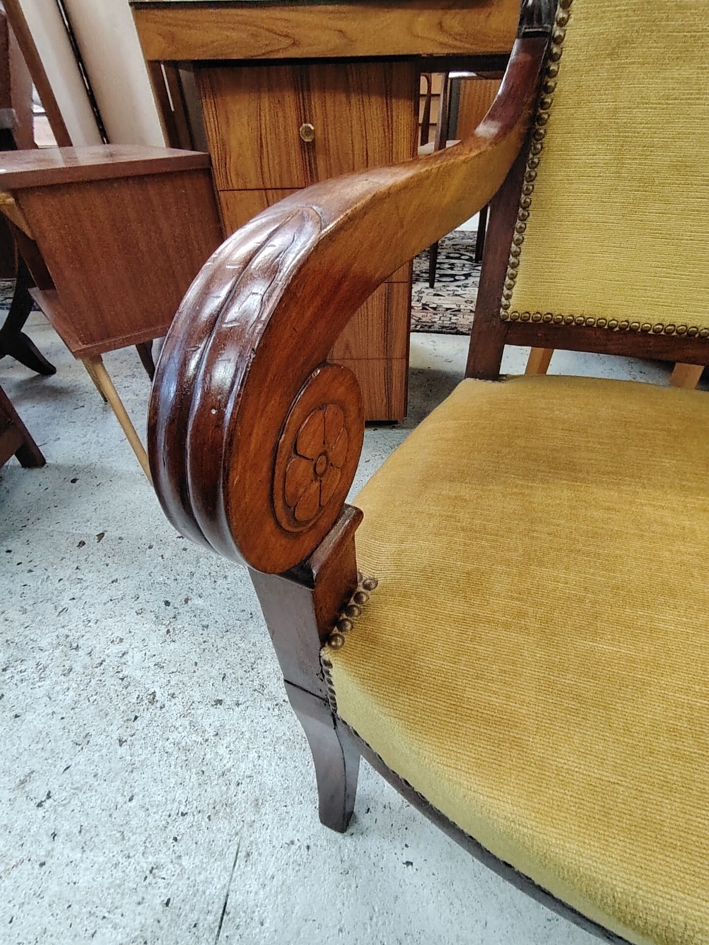 Armchair with scroll arms and sabre legs in mustard velvet, 19th century.