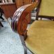 Armchair with scroll arms and sabre legs in mustard velvet, 19th century.