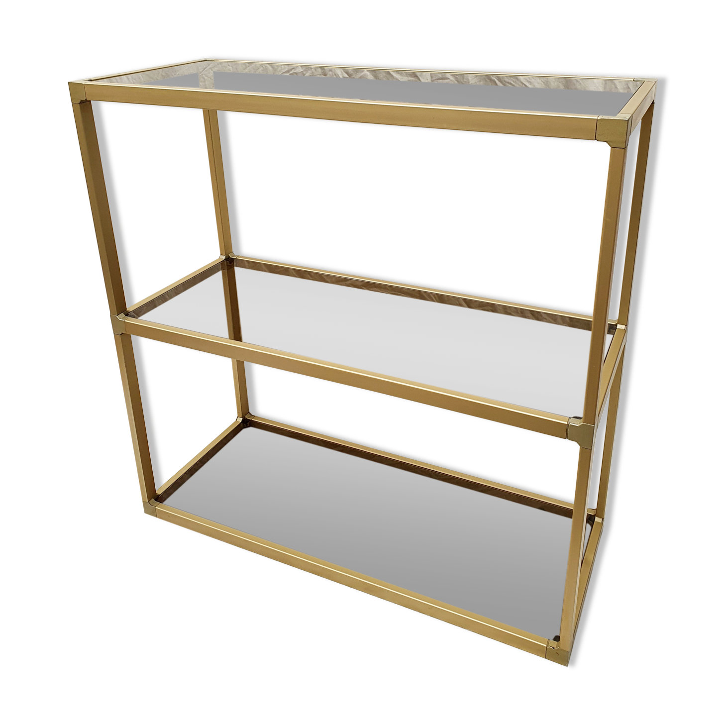 Golden metal shelf and smoked glass