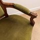 Antique armchair in olive green velvet and carved wood.