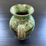 Old pitcher with ethnic decor