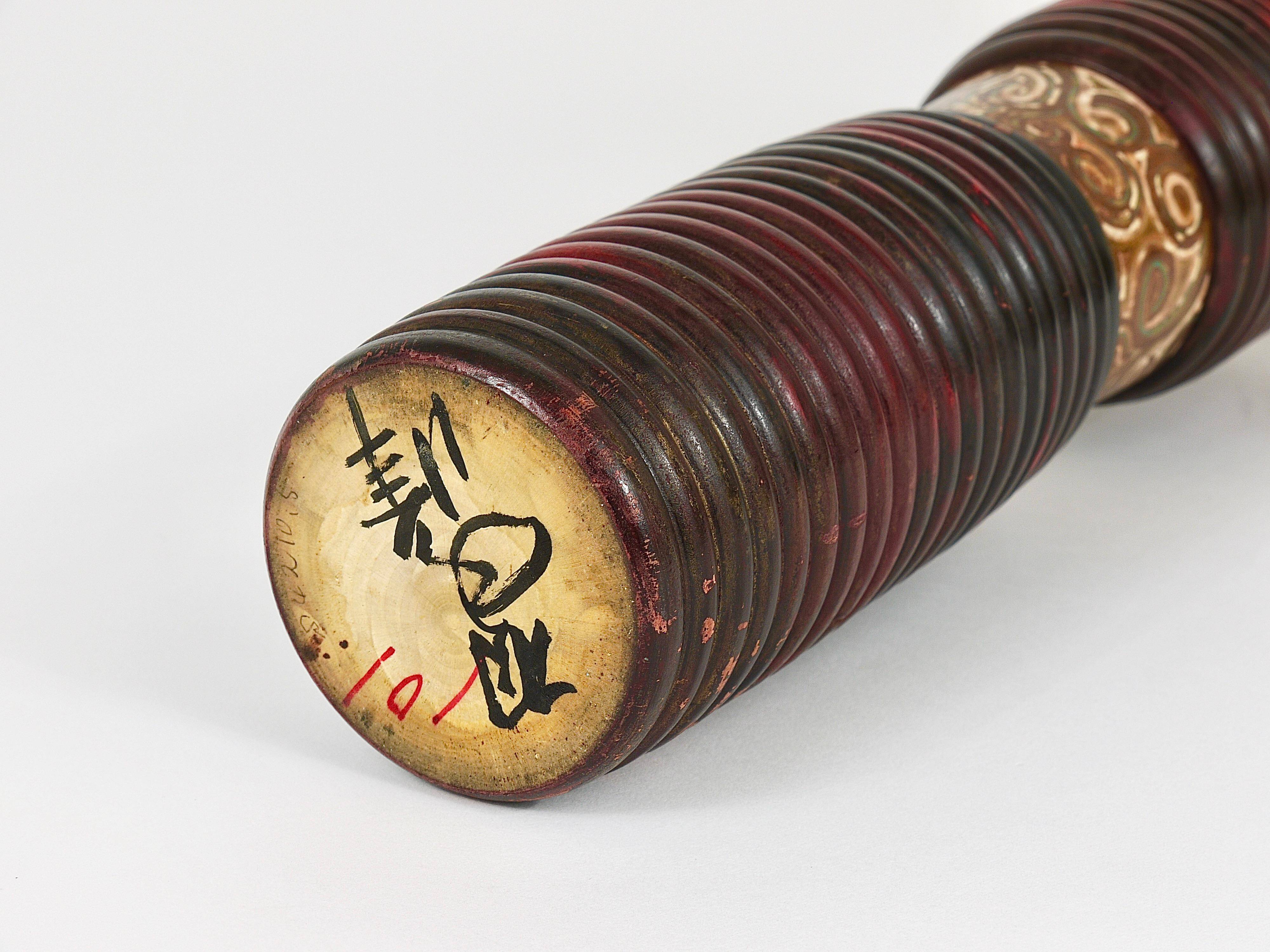 Decorative Kokeshi doll sculpture from northern Japan, hand-painted, signed.