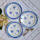 Mismatched old dessert plates accompanied by a dish