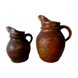 Duo of pitchers in ancient sandstone