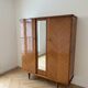 Retro wooden veneer wardrobe: 3 doors with mirror and tapered legs.