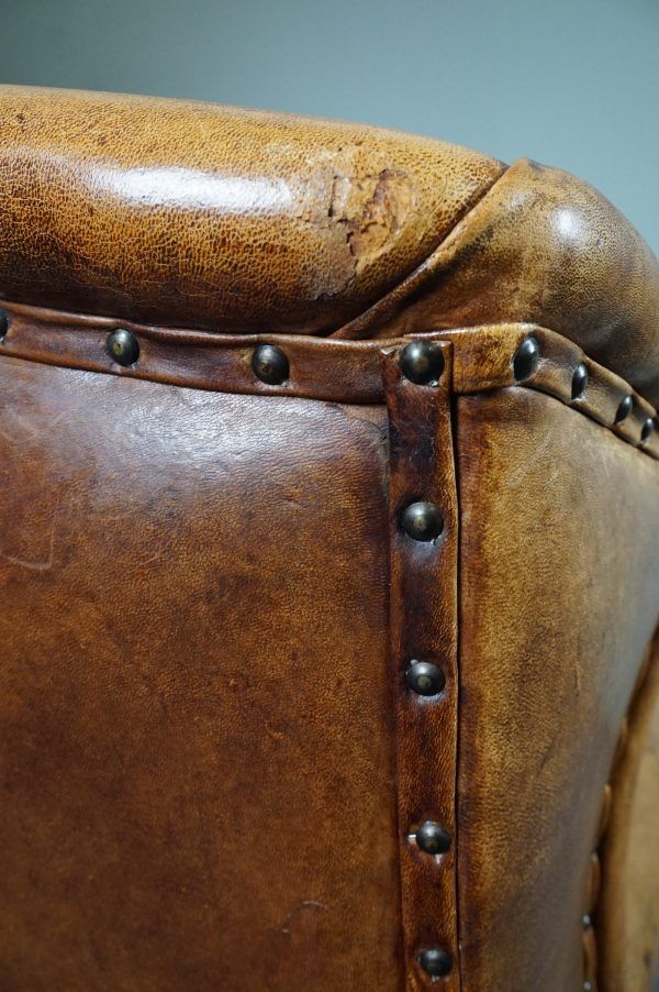 Antique armchair in patinated sheepskin
