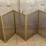 Five-panel golden metal fireplace screen from the 19th century.