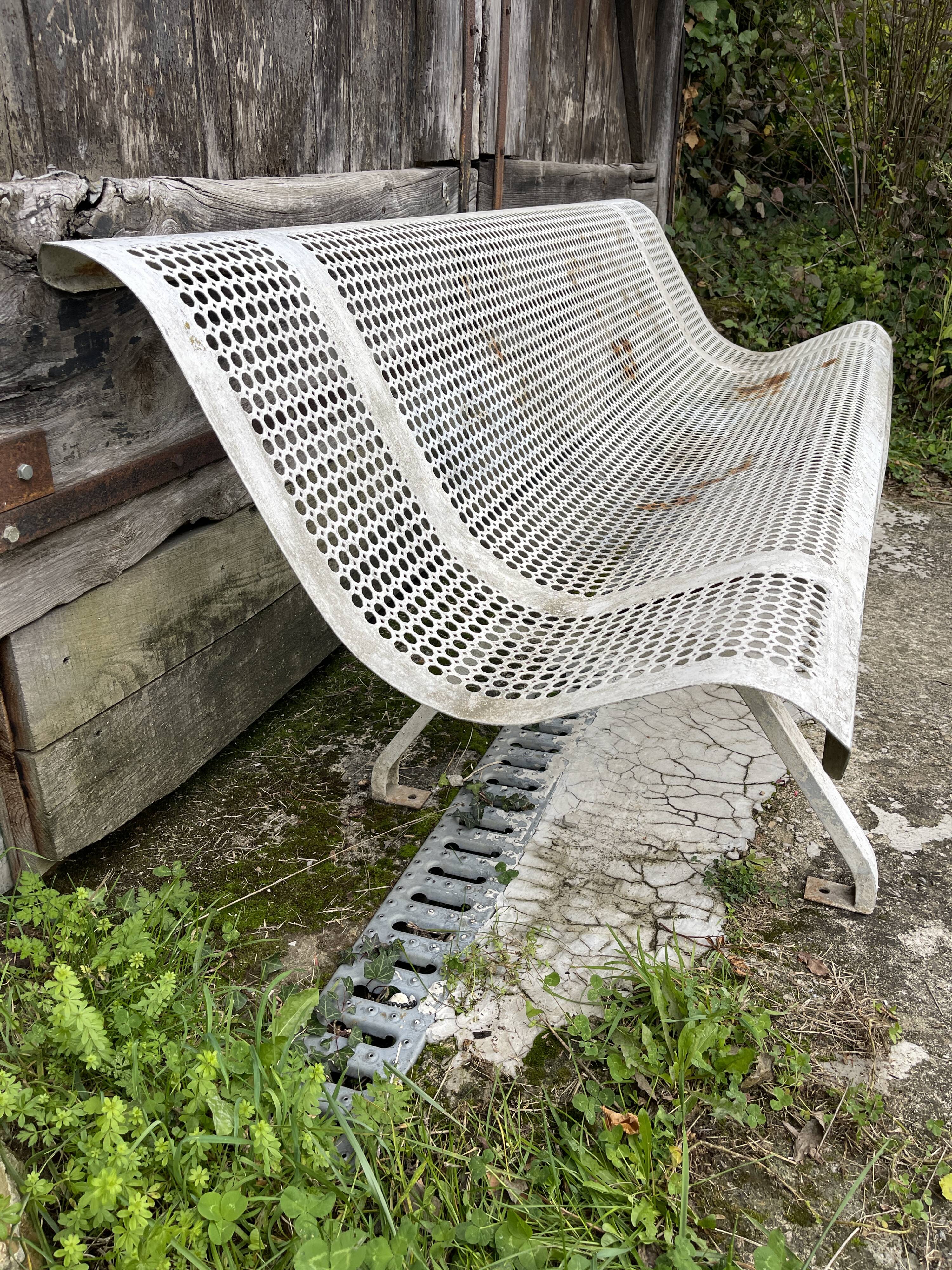 Old perforated metal garden bench