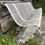 Old perforated metal garden bench