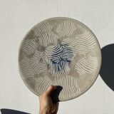 Round ethnic handmade fish dish