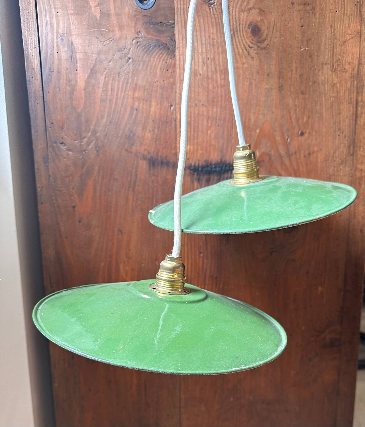 Set of two vintage green and white enamelled sheet metal lampshade pendants