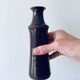 Tubular vase in glazed brown sandstone