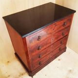 Antique chest of drawers with mahogany veneer and lion heads