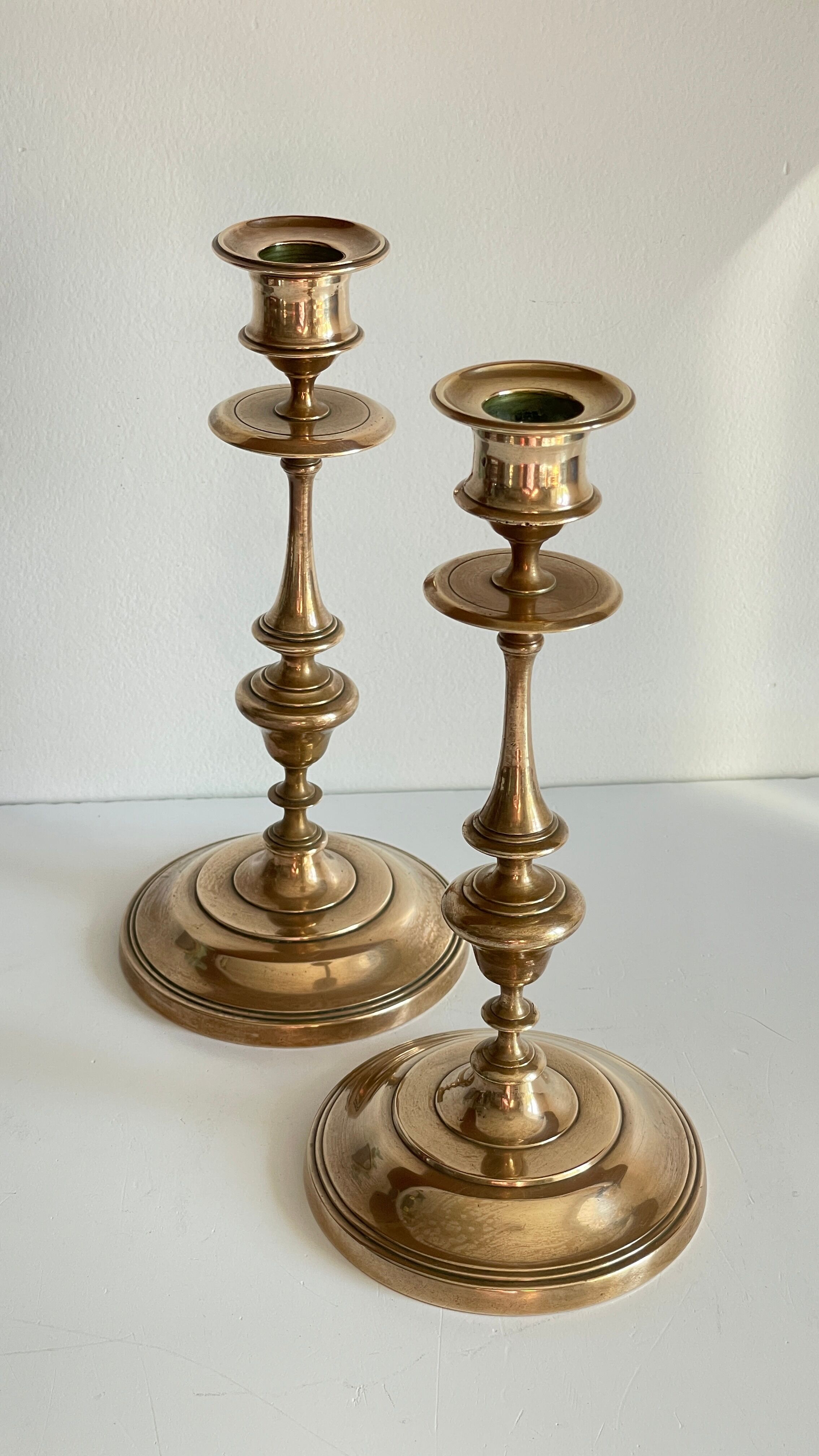 Pair of antique candle holders in solid brass