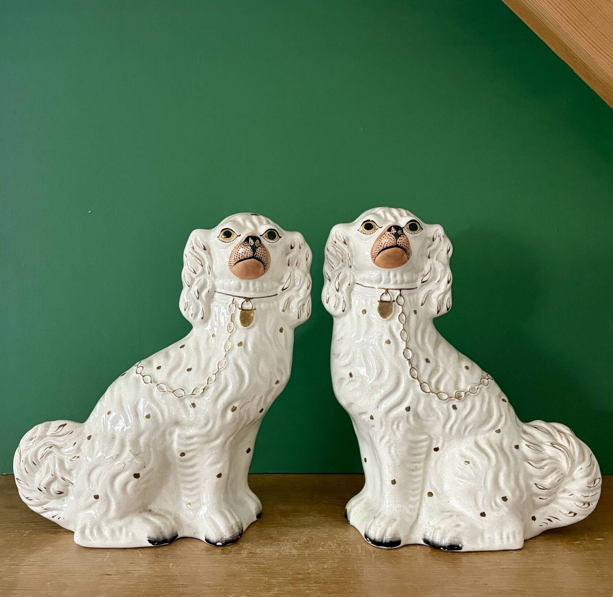 Pair of Staffordshire-type dogs in white and gold ceramic