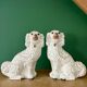 Pair of Staffordshire-type dogs in white and gold ceramic