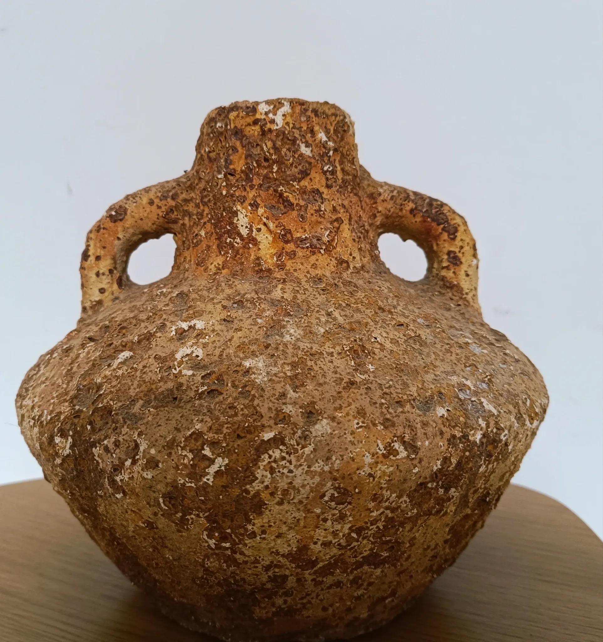Textured terracotta vase in wabi-sabi style
