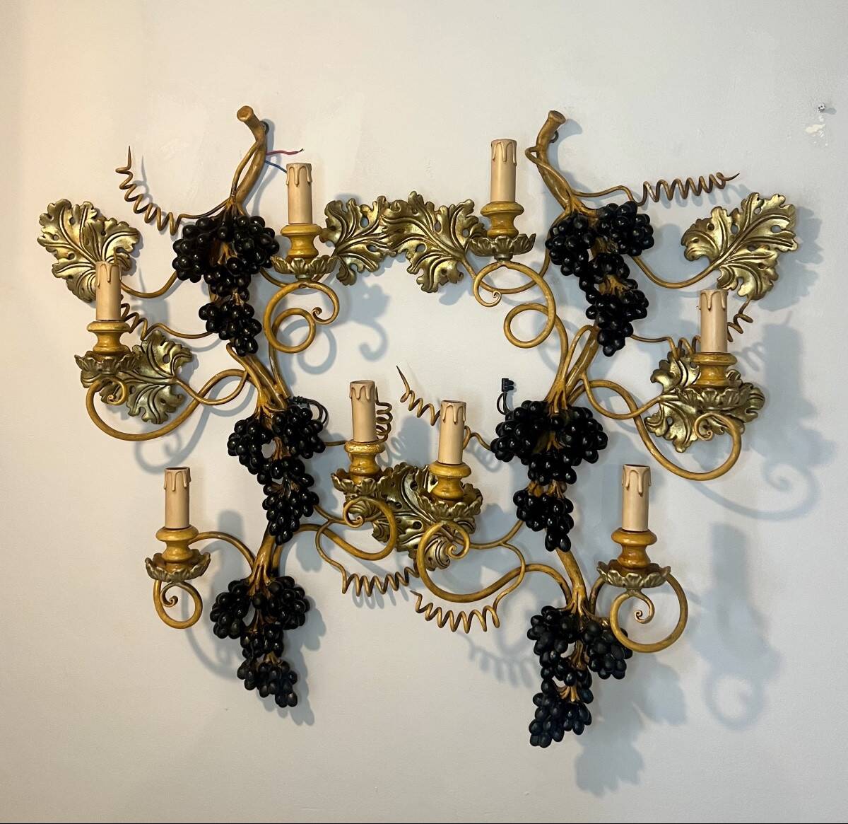 Large pair of wall sconces with vine decorations.