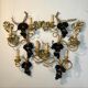 Large pair of wall sconces with vine decorations.