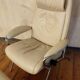 Beige leather armchair and footstool