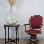Vintage captain's chair in wood and garnet fabric — a seat with character