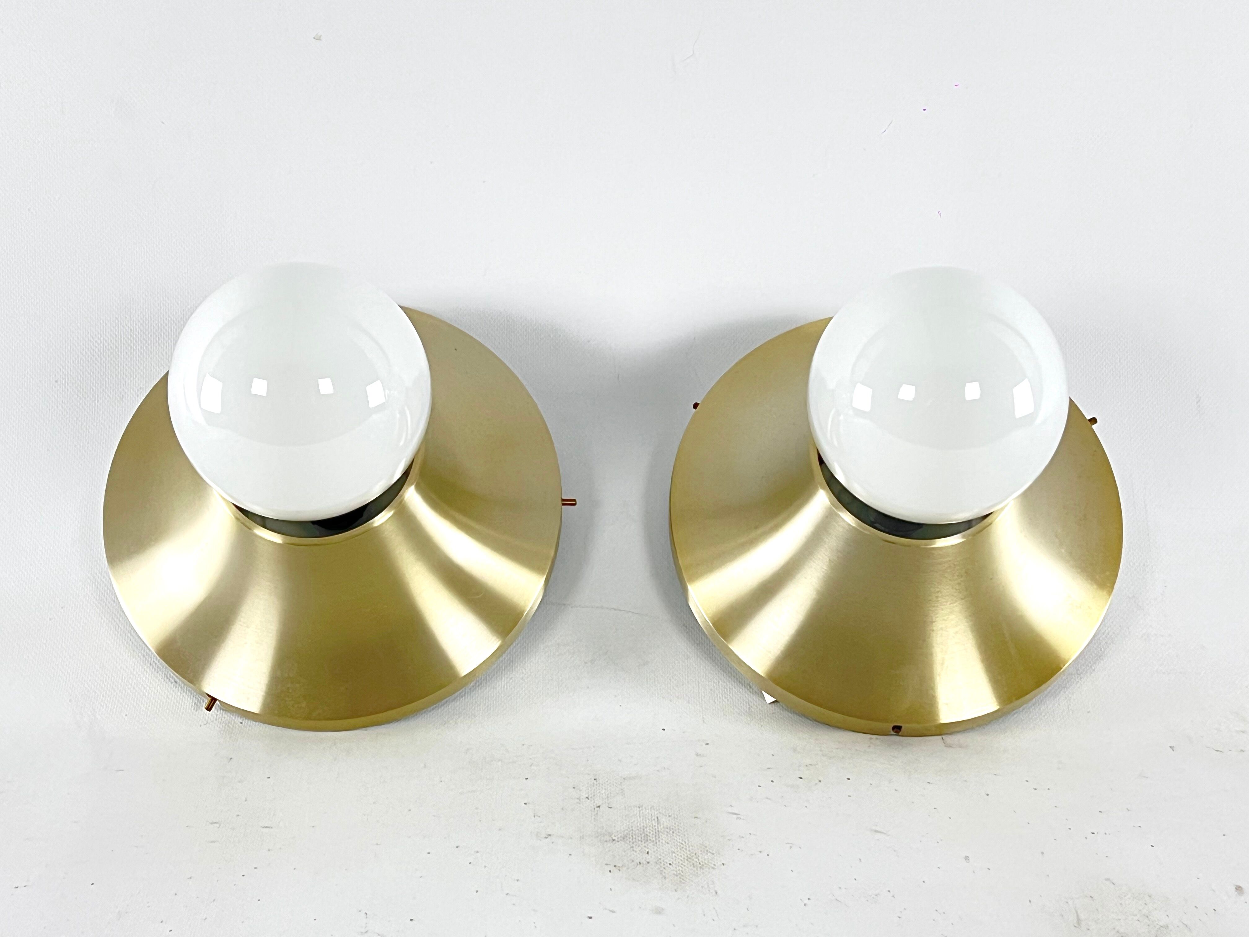 Stilux Milano, vintage round gilded aluminum wall lamps from 60s. Set of two