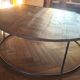 Large round coffee table in wood and wrought iron.