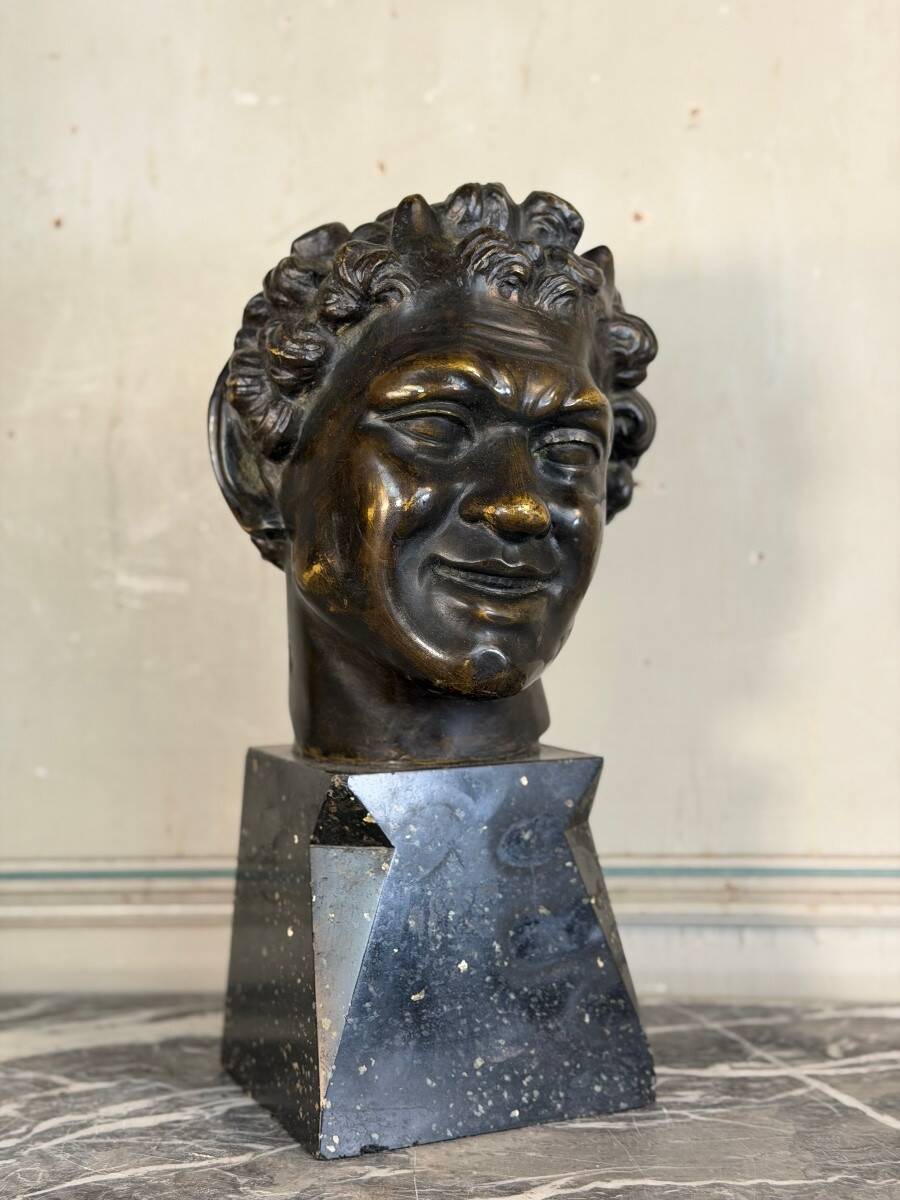 Head of a faun smiling, bronze after the antique, 19th century.