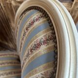 Pair of Louis XVI style chairs in painted wood and satin, classic elegance.