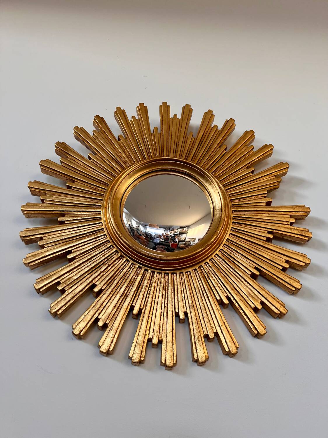 Old large golden sun mirror with rounded witch's eye in vintage resin from the 70s