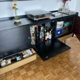 Black buffet cabinet including a bar and 3 drawers.