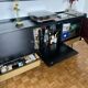 Black buffet cabinet including a bar and 3 drawers.