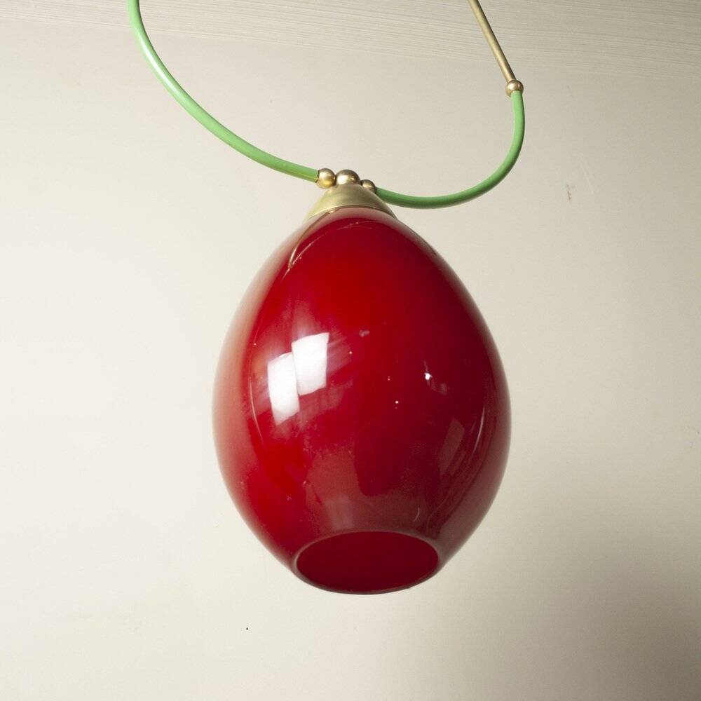 Hanging lamp with a brass frame in the shape of scales and a red-purple Murano glass diffuser.