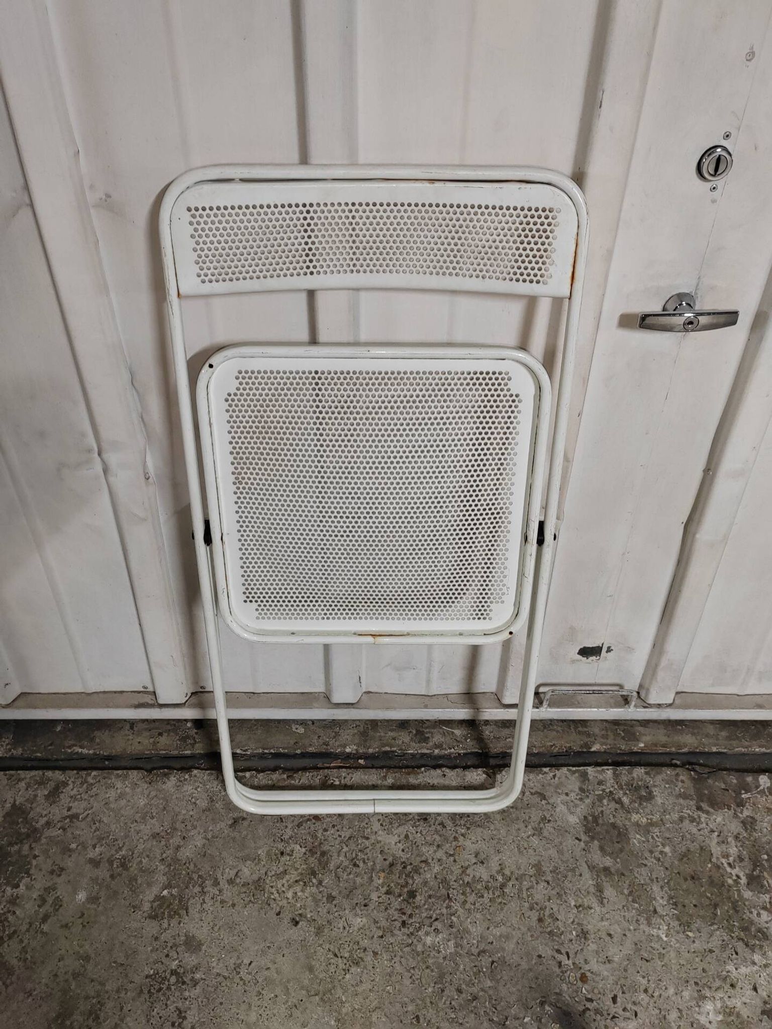 Perforated metal folding chair