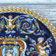 Round Gien renaissance dish with blue background