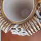 Sainte Radegonde ball vase in white and gold earthenware circa 1940-1950