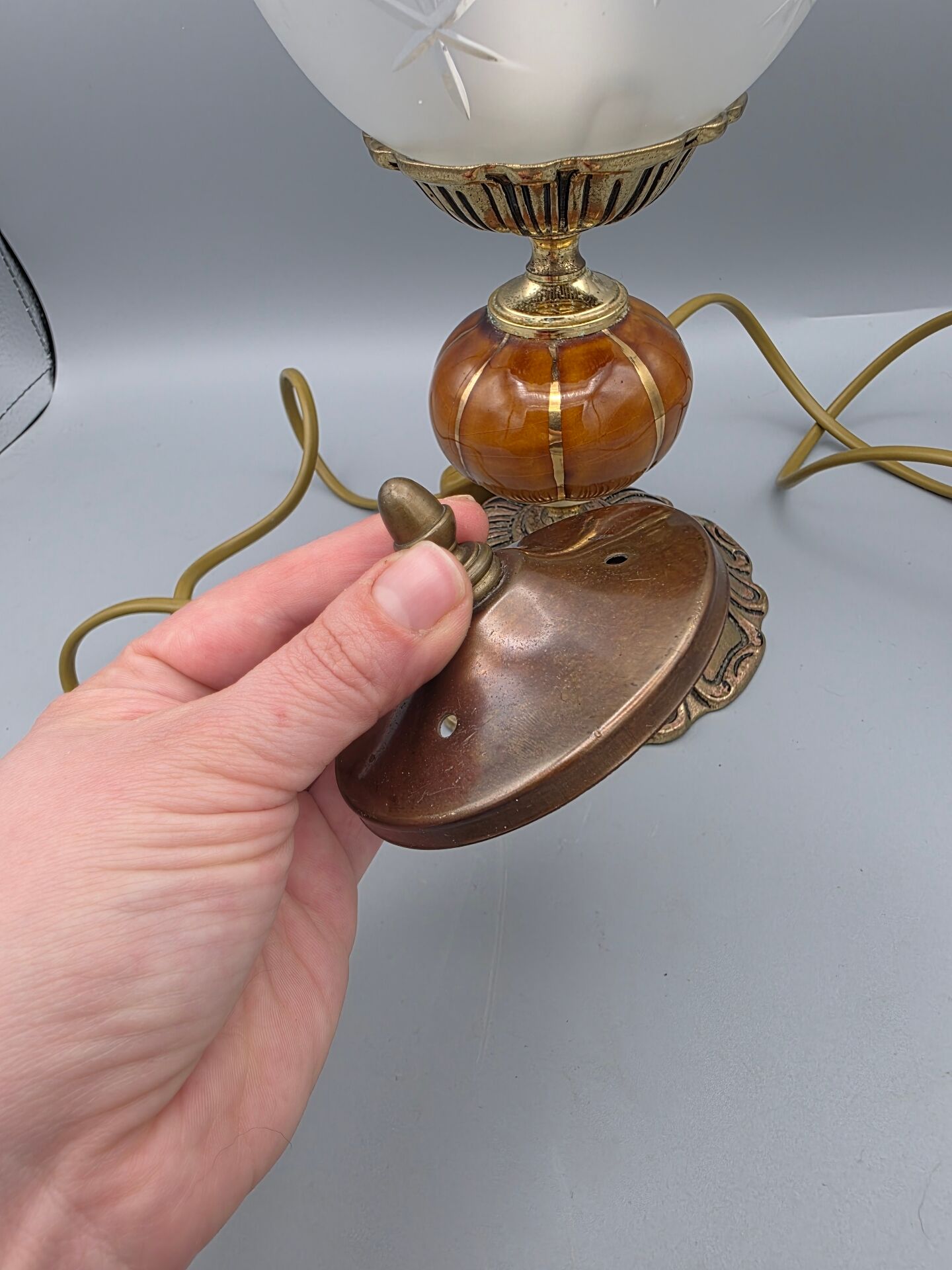 Hollywood Regency bedside lamp in gold metal with a glass globe.