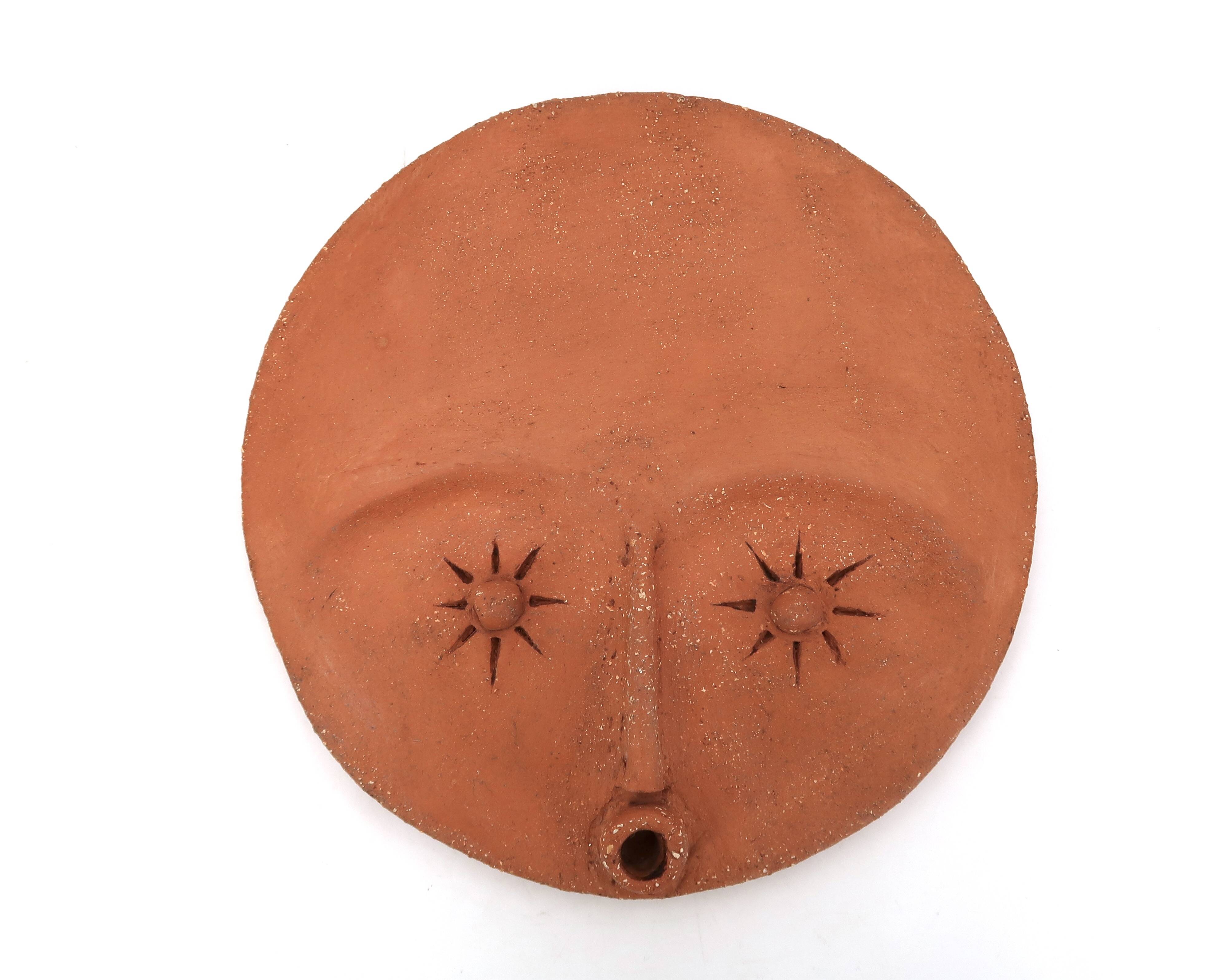 Round ceramic wall mask inspired by Africa, 1980s.