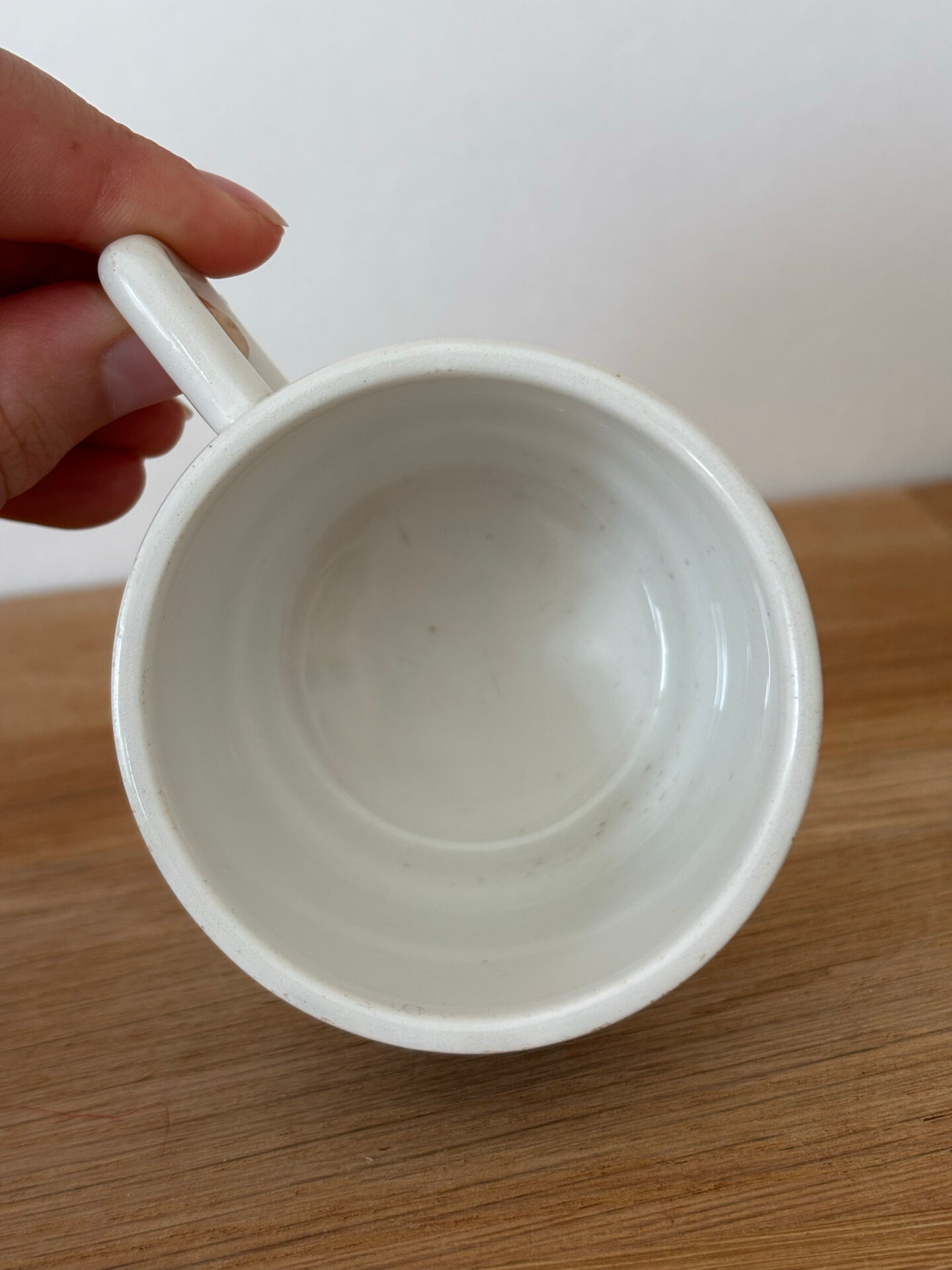Set of 2 antique earthenware cups with blue floral pattern.