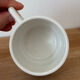 Set of 2 antique earthenware cups with blue floral pattern.