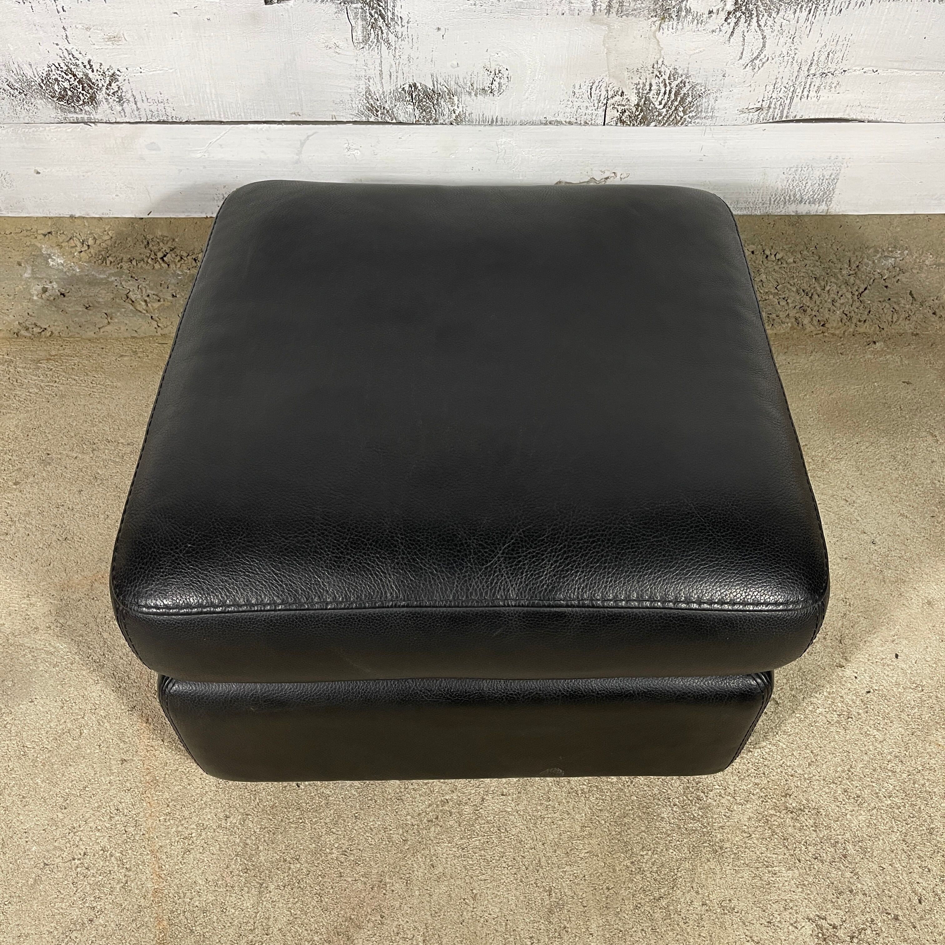 Black leather pouf