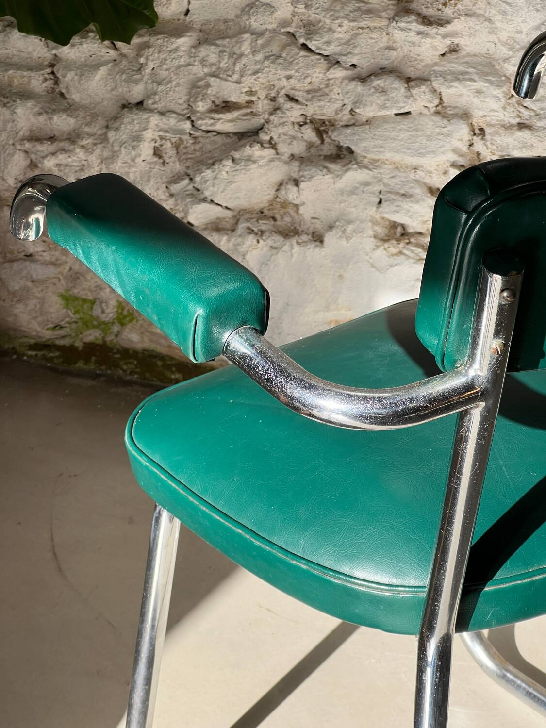 Pair of green vinyl and chrome armchairs, mid-century