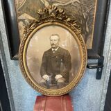 Old ancestor portrait in a gilded oval frame with Louis XVI style knot decoration