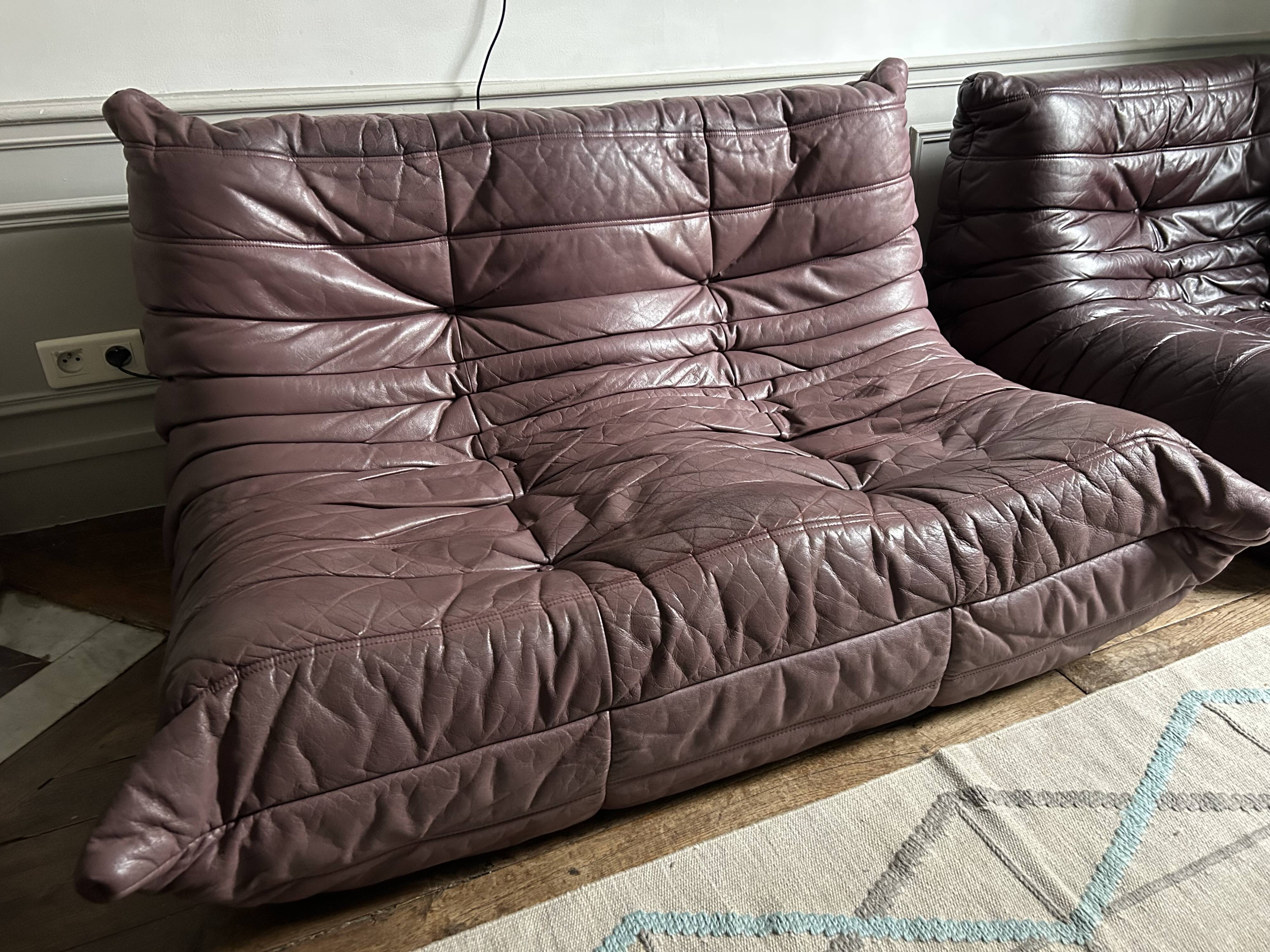 Togo set by Ligne Roset in vintage pink, plum, and burgundy leather.